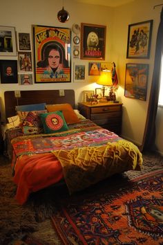 a bed room with a neatly made bed and lots of pictures on the wall