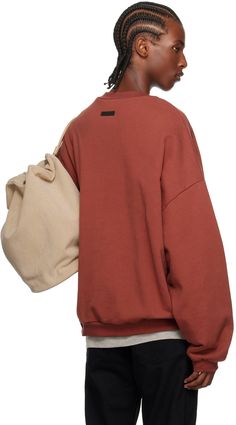 Heavyweight cotton fleece sweatshirt. · Rib-knit crewneck, hem, and cuffs · Logo appliqués at front · Seam pockets · Dropped shoulders · Rubberized logo patch at back collar Supplier color: Crimson Crimson Lipstick, Fear Of God Essentials, Fear Of God, Mens Essentials, Knit Crewneck, Fleece Sweatshirt, Cotton Fleece, Patch Logo, Crewneck Sweatshirt