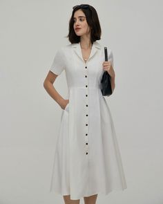 Fabric: The White Midi Dress is made of Polyester. Polyester is an artificial fiber that feels soft, looks lustrous, and dries fast. It's also durable, with good resistance to wrinkles, stains, and sunlight. Description: Crafted with meticulous attention to detail, this short sleeve midi dress features a classic lapel collar and short sleeves, adding a touch of tailored refinement to the silhouette. The button-up front not only lends a sense of polish but also offers versatility, allowing you to Single-breasted Solid Dress, White Button-up Solid Color Shirt Dress, White Button-up Shirt Dress, White Solid Color Button-up Shirt Dress, Classic White Button-up Dress, Spring A-line Single Breasted Dress, Summer Collared Single Breasted Dress, Summer Collared Single-breasted Dress, White Single-breasted Spring Dress