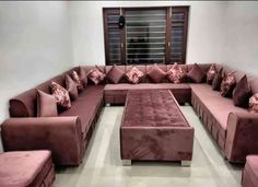 a living room filled with lots of pink couches