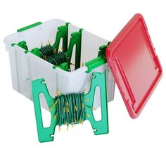 an open plastic container with green and red handles