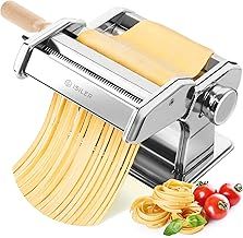 a pasta maker with noodles and tomatoes next to it