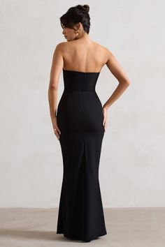 Mastering the balance between sophisticated and sultry, this black maxi dress is guaranteed to leave a lasting impression at any social gathering. Enticed boasts a boned corset bodice and supportive wired neckline thats beautifully adorned with multiple floral corsages. Pair yours with some stilettos like Oh Please for a luxurious black tie look.Features - Premium stretch crepe- Wired v neckline- Boned corset bodice- Floral corsages- Invisible zip closure- Maxi length Sizing & Fit Model is 5'8" and wears UK size 8 / US size 4Product Information Designed exclusively by Club L London Fully lined with some stretch Premium crepe in Black (87% Polyamide, 13% Elastane) 157cm total length SKU: CL132273002 Long Black Dress Formal, Black Strapless Maxi Dress, Strapless Bridesmaid Dress, Bandeau Maxi Dress, Dress Display, Dress With Flowers, Velvet Prom Dress, Halter Neck Maxi Dress, Club L London