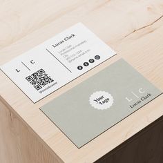 a close up of a business card on top of a wooden table with a qr code