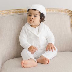 Handmade in the USA One of the most popular baby boy dress suits from Baby Beau & Belle! The all white Elijah Baby Boy 3-Piece Suit is a mix of the softest, luxurious textured cotton and an elegant design, perfect to keep your little guy cozy and warm on his special day! The fitted style pant features pleated front creases, a grosgrain ribbon and button waist and a stylish back pocket. The adorable jacket features a fold over collar and darling front pockets. Not a detail is missed on this hands White Cotton Baptism Sets, White Cotton Sets For Baptism, White Cotton Formal Sets, Classic Long Sleeve Sets For Baptism, Classic White Sets For Baptism, Classic White Set For Baptism, Baby Boy Formal Wear, Boy Dress