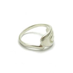 a silver ring sitting on top of a white surface