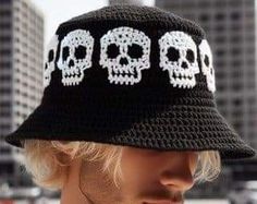 a man wearing a black hat with white skulls on it