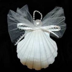 an angel made out of seashells with pearls on it's back and wings