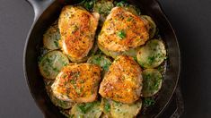 chicken and potatoes in a skillet with parsley sprinkled on the side