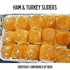 a tray filled with lots of sliders covered in cheese and toppings next to the words ham & turkey sliders