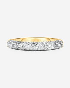 a yellow gold wedding band with pave diamonds