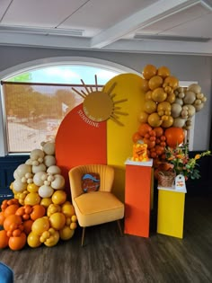 an orange chair sitting in front of a display of balloons