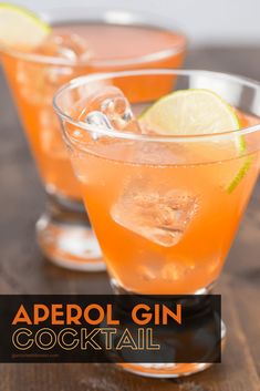 three glasses filled with orange liquid and limes on a wooden table, ready to be served