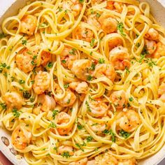 pasta with shrimp and parsley in a white bowl