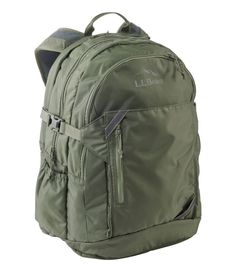 a green backpack with zippers on the front