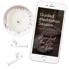 the guided meditation session on an iphone next to ear buds and a cup of coffee