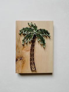 a wooden plaque with a palm tree on it