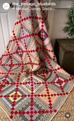 the vintage bluebirds quilt is on display in front of a door with a christmas tree