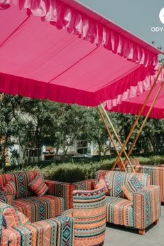 colorful couches and chairs under a pink awning