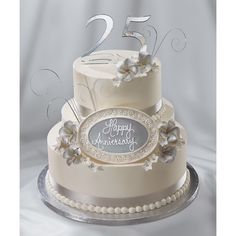 a white wedding cake with silver decorations and the number twenty five