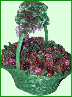 a green basket filled with pine cones and christmas decorations