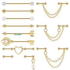 a set of different types of piercings with chains and hearts on them, including an arrow