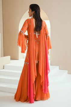 Orange peplum kurta with floral embellishments in pearls, glass beads and white beads. Comes with gharara and ombre dupatta.
Components:3
Pattern:Embellished
Type of Work:Floral Motifs
Neckline:V-Neck
Sleeve Type:Umbrella Sleeves
Fabric:Kurta: Georgette, Gharara: Organza and Crepe, Dupatta: Chiffon, Lining: Satin
Color:Orange
Other Details:
Asymmetric kurta
Back cut-out with tassel tie-up
Ombre dupatta
Occasion:Sangeet - Aza Fashions Peplum Gharara, Umbrella Sleeves, Ombre Dupatta, Designer Sharara Suits, Designer Sharara, Asymmetric Kurta, Sharara Suits, Satin Color, Fashion App