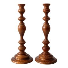 two wooden candlesticks sitting next to each other