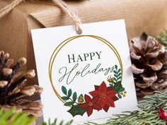 a holiday gift tag with poinsettis and pine cones on the table next to it