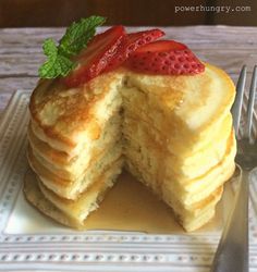 a stack of pancakes with strawberries on top