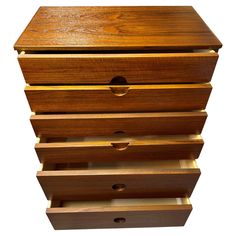 three wooden drawers stacked on top of each other with one drawer open and the other closed