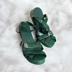 Step Into Style With These Rare Vintage Flexiclogs Women's Sandals In A Beautiful Shade Of Green. These Sandals Feature An Articulated Design With A Wood Sole And Strap, Perfect For Any Casual Occasion. The Unique Style And Material Make These Sandals A Must-Have For Any Vintage Shoe Collector. These Sandals Are Perfect For Those Who Love The Art Of Nature. The Green Color Adds A Touch Of Freshness To Any Outfit. Ideal For Those Who Love Sandals And Flip Flops, These Flexiclogs Sandals Are A Gre Green Ankle Strap Heels With Wooden Heel, Green Sandals With Wooden Open Heel, Green Wedge Sandals With Heel Strap And Round Toe, Green Open Heel Sandals With Rubber Sole, Green Closed Toe Sandals With Wooden Heel, Green Open Toe Vintage Sandals, Vintage Green Open Toe Sandals, Green Vintage Open Toe Sandals, Green High Heel Sandals With Wooden Heel