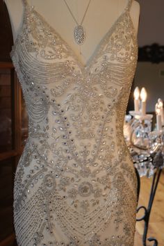 a dress on display with candles in the background