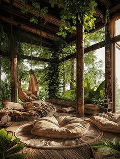 a room filled with lots of pillows next to a window covered in green plants and hanging chairs