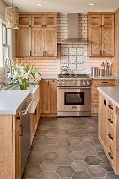 a kitchen with wooden cabinets and tile flooring