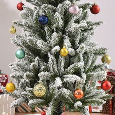 a small christmas tree with ornaments on it