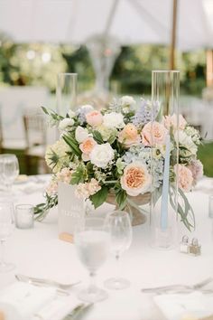 a table topped with lots of flowers and candles