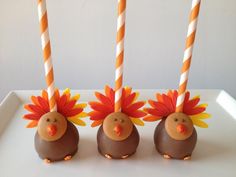 three chocolate covered turkeys with candy sticks in the shape of heads on top of each other