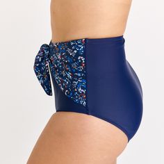 Step up your beach style with our High-Waisted Bikini Bottom featuring a chic front tie detail. Sized to perfection, the hem circumference is 62 cm and the thigh circumference is 49 cm for a Size S. When in doubt, it's best to size up for a comfortable fit. Crafted from 82% nylon and 18% spandex, this fully-lined bikini bottom offers UPF 50+ sun protection and quick-drying capabilities. Sold as a bottom only, you have the freedom to mix and match with your favorite tops. Keep it fresh and vibran Navy Swimwear For Swimming, Navy Fitted Swimwear For Swimming, Fitted Navy Swimwear For Swimming, Adjustable Blue Tankini For Vacation, Navy Summer Tankini For Beach Season, Navy Stretch Swimwear For Beach Season, Stretch Navy Swimwear For Beach Season, Fitted Navy Tankini For The Beach, Navy Slim-fit Bottoms For Vacation