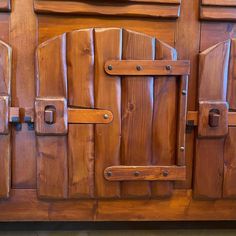 a close up of a wooden cabinet with metal handles