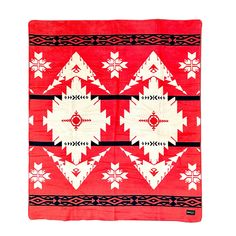 a red blanket with white and black designs on it