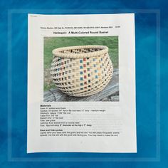 a newspaper article with a woven basket on the front and back cover in blue water