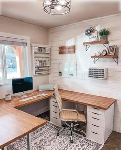 a home office with white walls and wooden desks