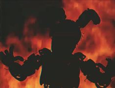 the silhouette of a man with his arms outstretched in front of a blazing fire background