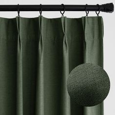 the curtain is closed and there is a round object hanging from it's rod