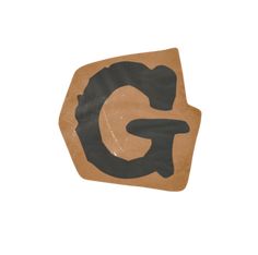 the letter g is made out of brown paper and black paint on top of it