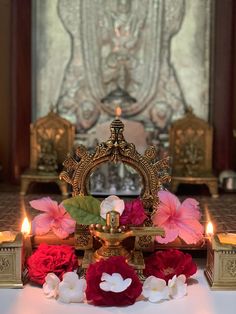 a crown with flowers and candles on a table