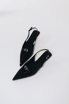 Nina features a pointed toe, low kitten heel, and a slim slingback strap in black patent leather for a sleek and streamlined silhouette. Size and Fit Information: U.S. Sizing Available in whole and half sizes Runs true to size (Note: Not using leather and other materials from animals significantly reduces environmental impact, however, we acknowledge that synthetic alternatives are not without environmental concerns. As we grow, we are dedicated to finding alternative materials that are even safer for the planet.) Composition: 1.5"/40 mm heel Sole: Rubber 100% Vegan, Animal and Cruelty-Free Imported Sleek Low Heel Slingback Pumps For Evening, Sleek Slingback Pumps With Single Toe Strap For Evening, Low Heel Patent Leather Slingback Sandals With Sculpted Heel, Sleek Low Heel Slingback Sandals For Evening, Chic Black Kitten Heels With Single Toe Strap, Patent Leather Slingback Sandals With Sculpted Heel, Black Patent Leather Slingback Sandals With Low Heel, Sleek Pointed Toe Slingback Sandals, Patent Leather Slingback Kitten Heels For Party