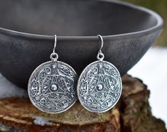 "Handmade sterling silver or 14-K gold-plated sterling silver earrings in form of a Viking shield. Inspired by a find in Sweden, in the 11th century. The same design pendant and earrings in bronze are also available. You can find the here: https://www.etsy.com/listing/1189914979/ If you would like to order these earrings in rose gold plating or made from pure 14-K yellow or rose gold, please, contact us to make a custom order! PRODUCT DETAILS Earrings: -Diameter: 35 mm/ 1.38\" -Drop length: 45 m Silver Engraved Round Earrings, Silver Symbolic Pendant Earrings, Symbolic Silver Pendant Earrings, Round Engraved Sterling Silver Earrings, Engraved Sterling Silver Round Earrings, Engraved Sterling Silver Earrings, Engraved Drop Earrings As Gift, Engraved Drop Earrings For Gift, Silver Symbolic Engraved Earrings