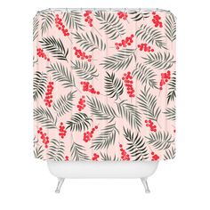 a pink shower curtain with red berries and leaves on the outside, against a white background